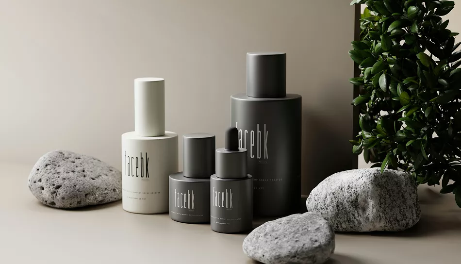 Minimalist skincare bottles in neutral gray and white packaging arranged with smooth stones and greenery on a beige background, creating a calm, modern aesthetic.